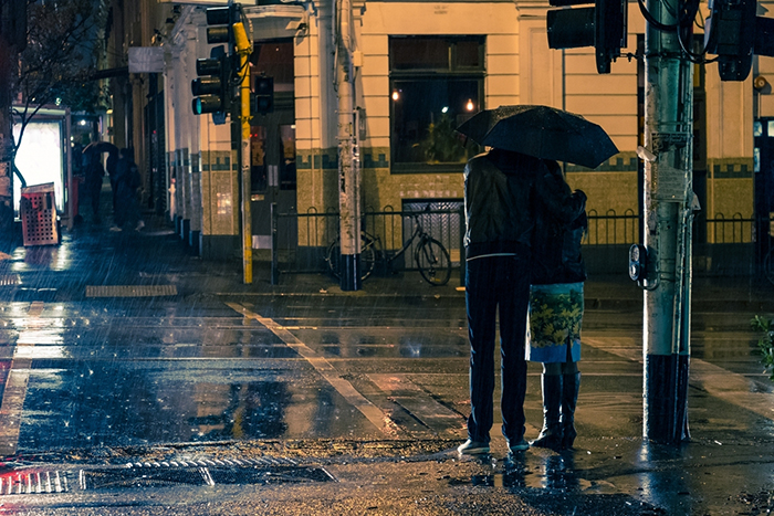 Two people crossing the road