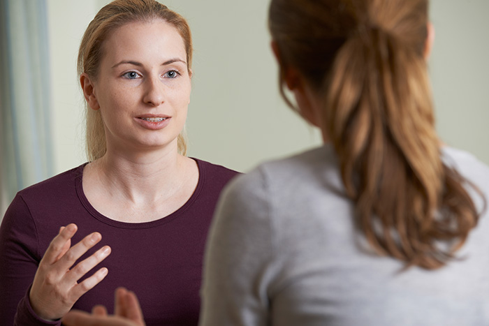 Two young women talking