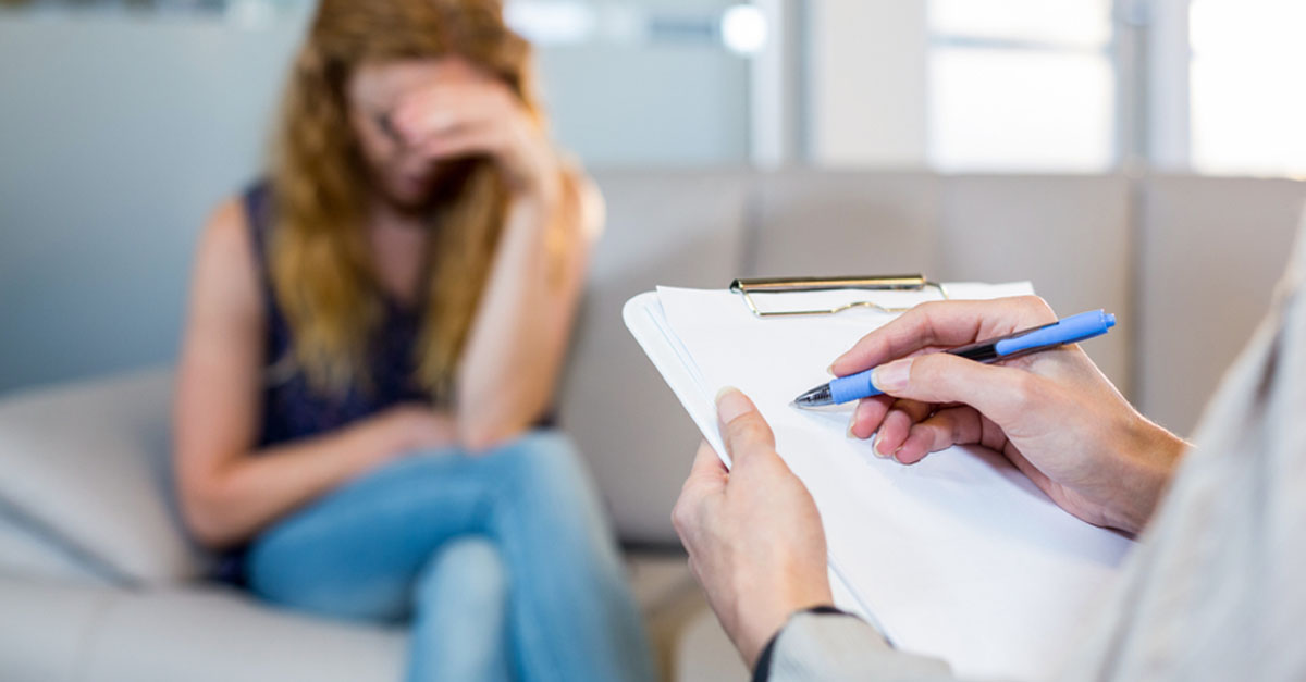 GP filling out a referral form for a patient.