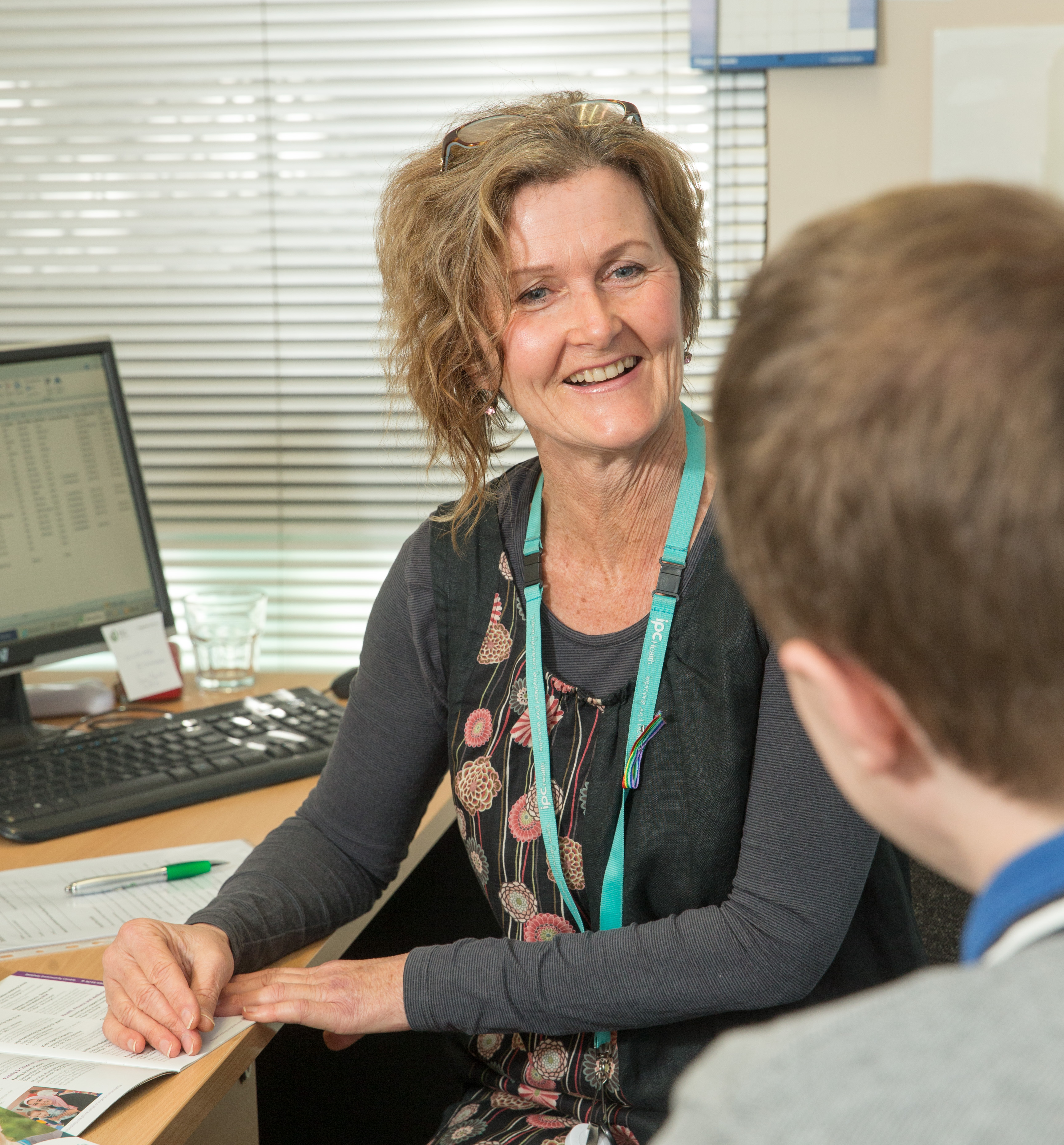 Catherine Cotching talking with a patient.