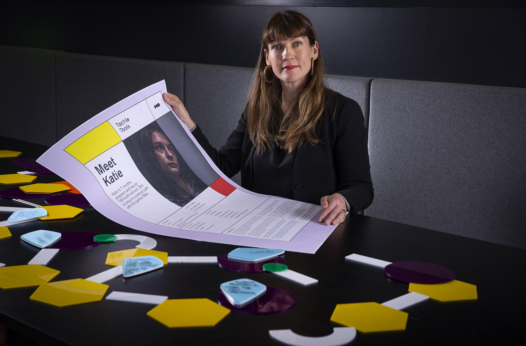 Dr Leah Heiss holding a poster of 'Katie'.