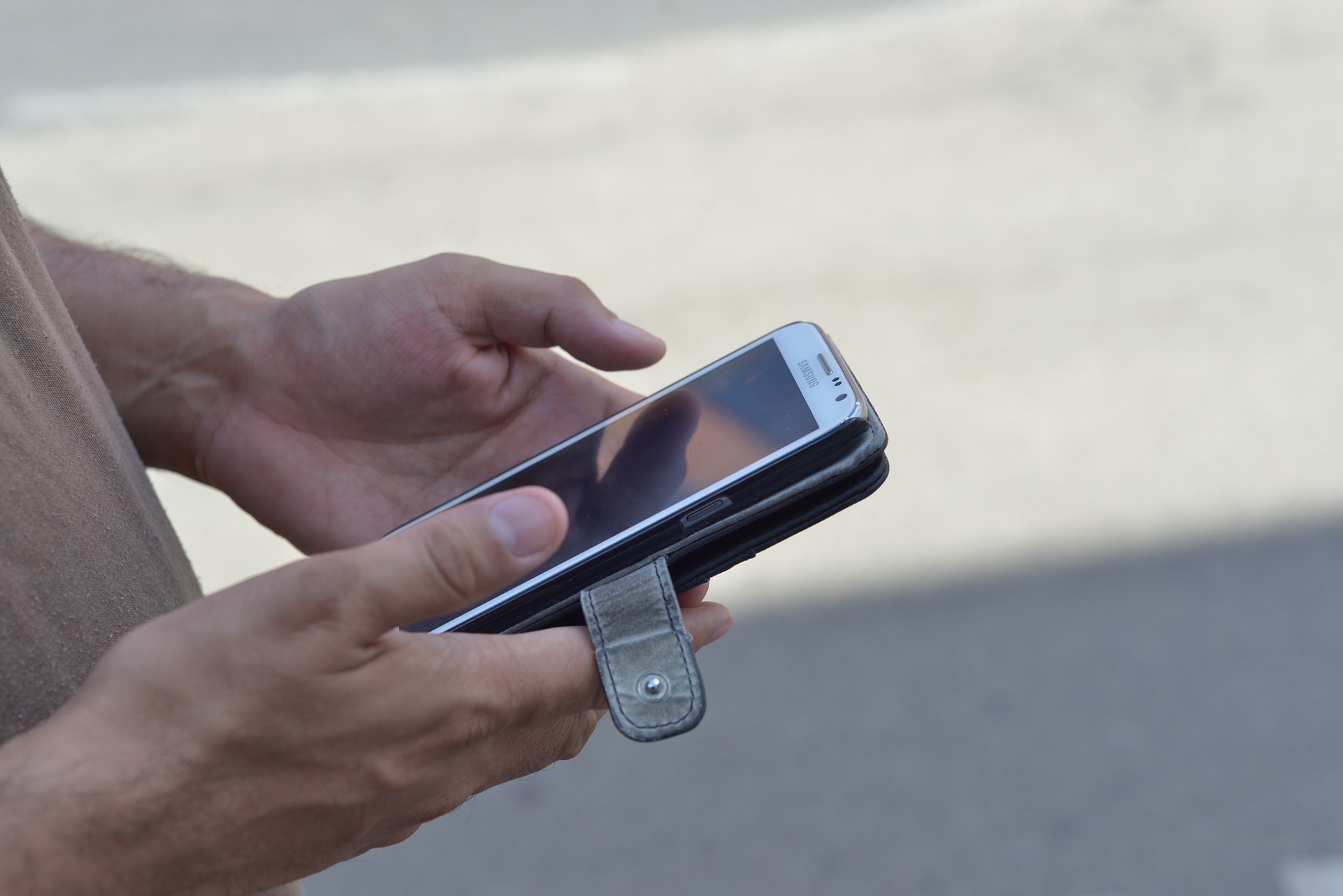 Person's hands holding an iPhone.