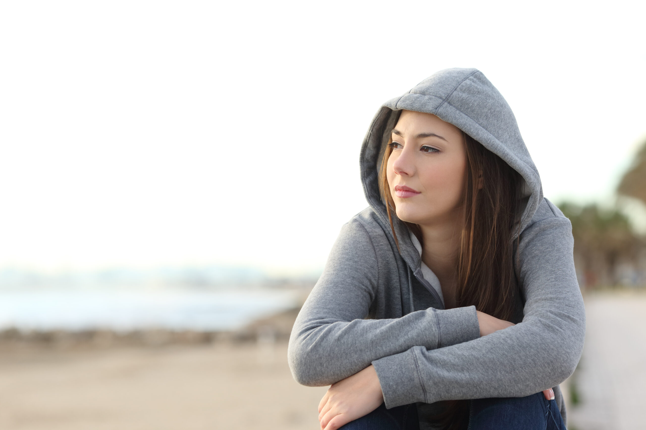 Young girl sitting on the beach