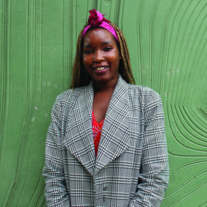 A portrait photograph of Yom Maker Adeng on a green background. 