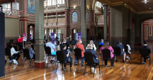 People waiting to receive their COVID-19 vaccine at the Royal Exhibition Building in Carlton.