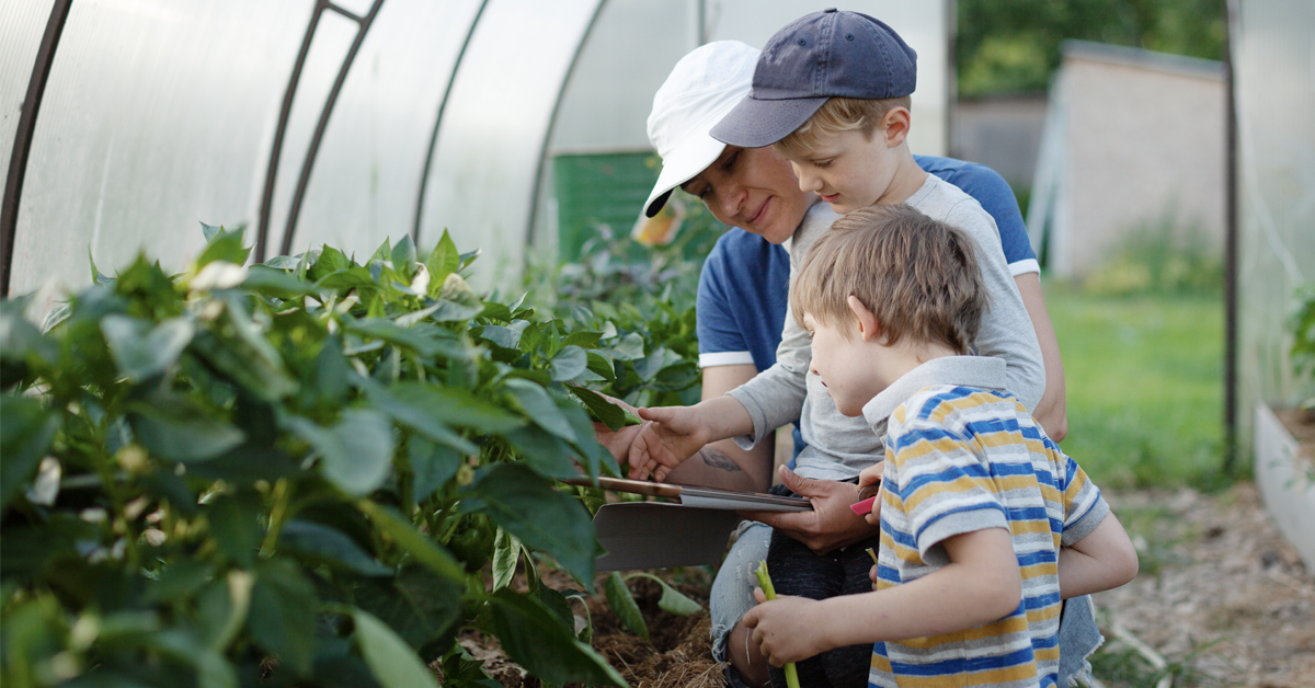 A family working together in a greenhouse.