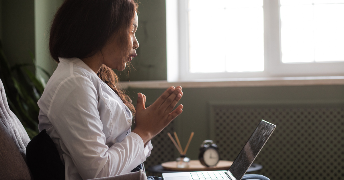 A patient talking with a mental health professional in a telehealth consultation.