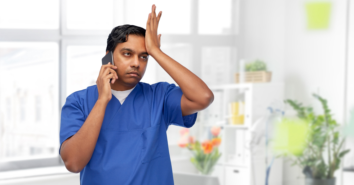 An exasperated doctor talking on the phone.