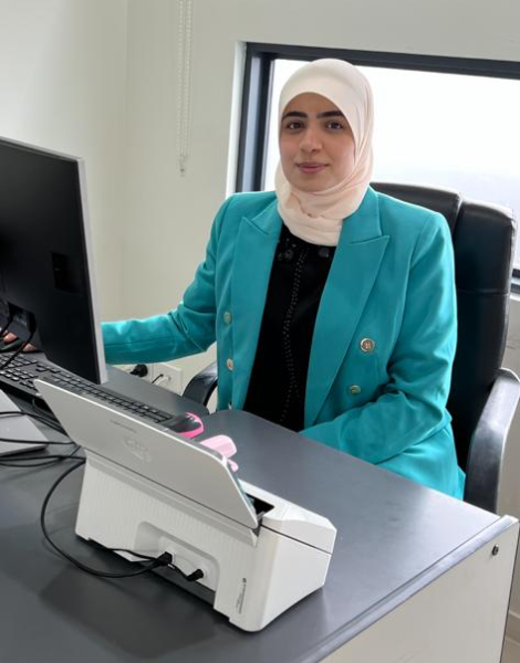 Photograph of Fawkner Health Care Practice Manager Farah Alkhayat sitting at a desk in the clinic.