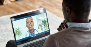 A patient talking to their GP using telehealth.