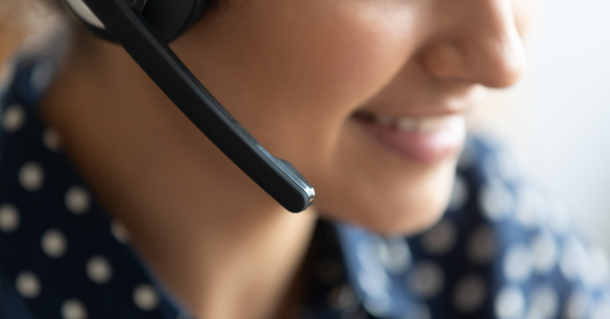 Close up of a woman's face talking on the phone.