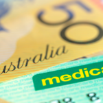 A $50 note sitting on top of a Medicare card.