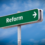 A green Victorian street sign with the word "reform".