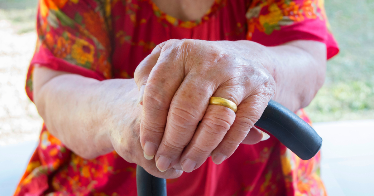 older lady holding walking stick