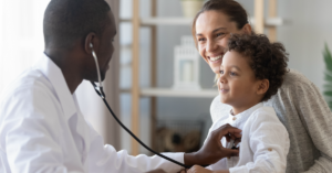 A primary care doctor performing a health check on a young child.