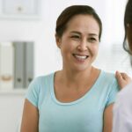 A woman experiencing pelvic pain speaks with a health professional