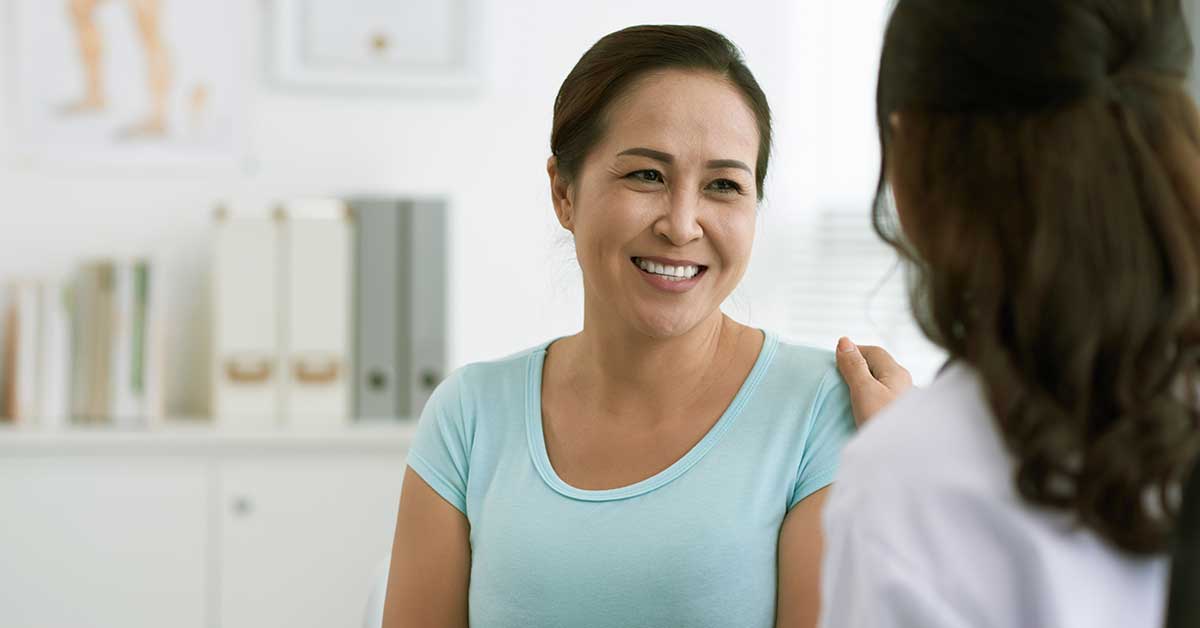 A woman experiencing pelvic pain speaks with a health professional