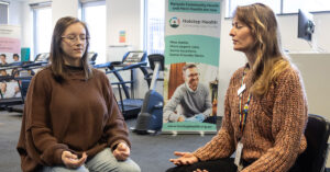 Chronic pain patient Amanda (left) does meditation exercises with Holstep Health senior pain physiotherapist Nicole Moore.