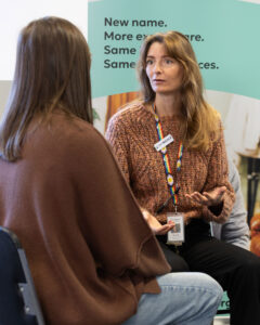 Holstep Health pain physiotherapist Nicole Moore talks with patient Amanda.