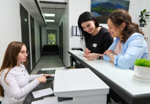 A practice manager speaks with both a general practitioner and receptionist