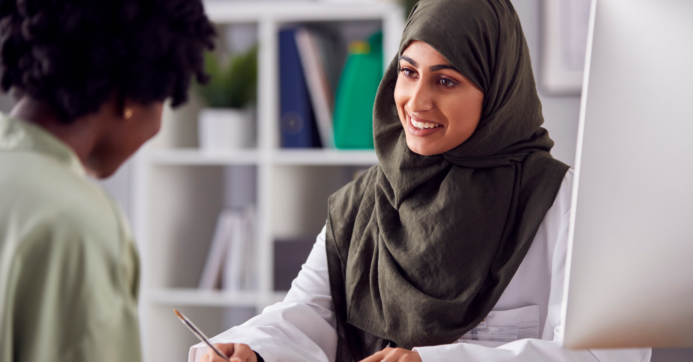 A practice manager speaking to a member of her team.