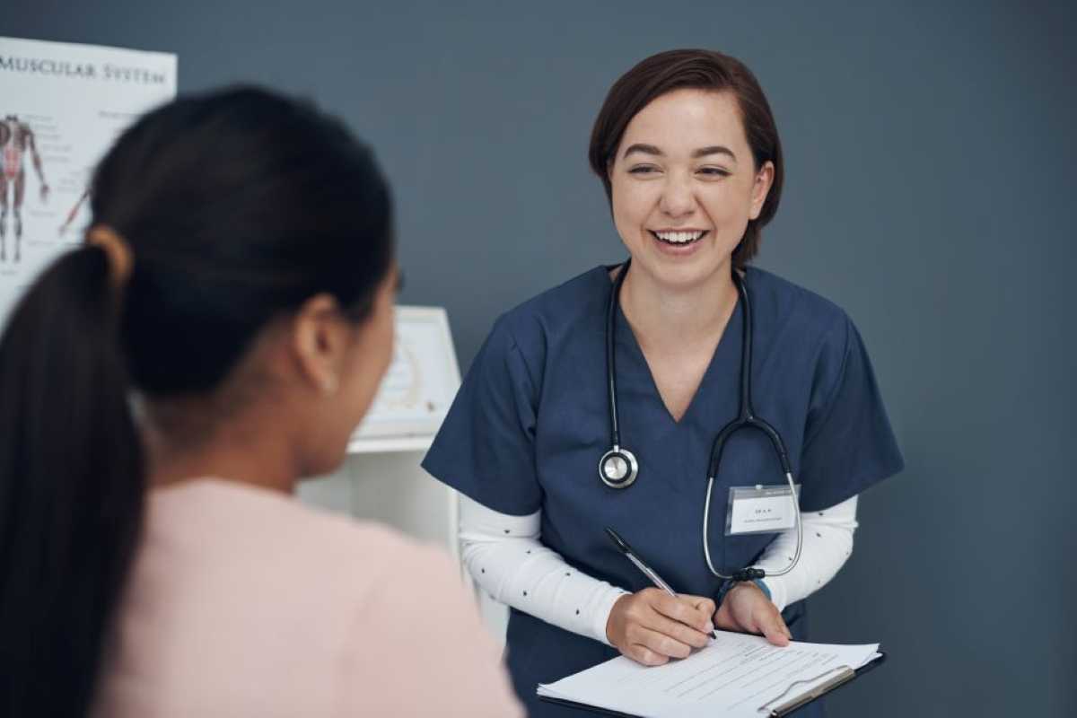 A female practice nurse speaks with a female patient