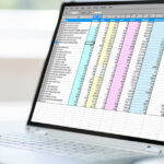 A health professional assesses a spreadsheet with patient data