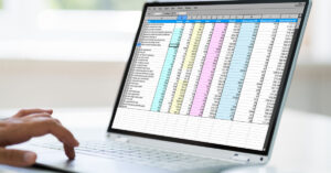 A health professional assesses a spreadsheet with patient data