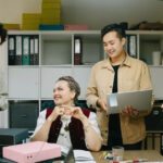 A multidisciplinary care team chat in the staff area of a general practice.