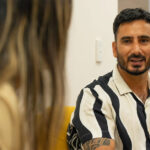 A man in his 30s speaks with a health professional about his mental health