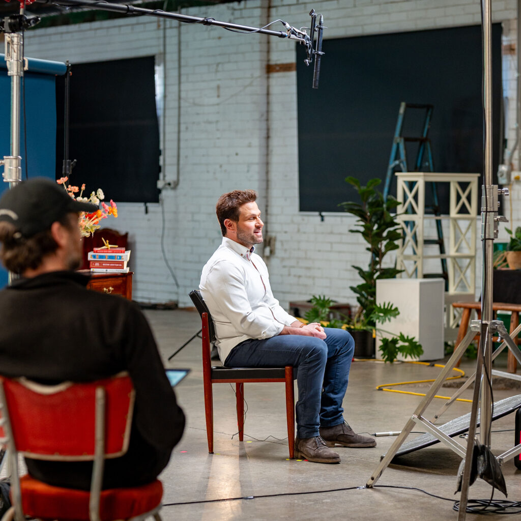 Dr Owen Harris speaks in front of a camera, as part of filming for the Raise It AOD stigma campaign