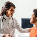 A female doctor speaks with a middle-aged female patient about lung cancer screening