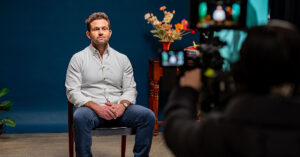 Dr Owen Harris speaks in front of a camera, as part of filming for the Raise It AOD stigma campaign