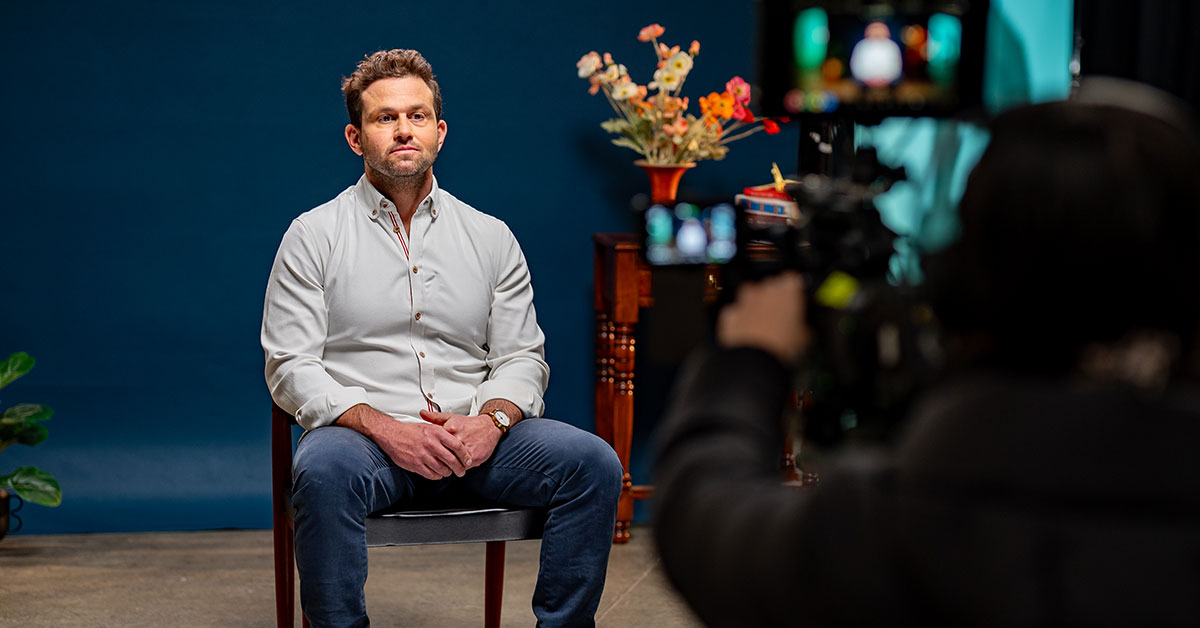 Dr Owen Harris speaks in front of a camera, as part of filming for the Raise It AOD stigma campaign