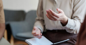 A female health professional takes notes and provides advice about endometriosis.