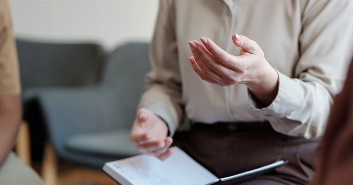 A female health professional takes notes and provides advice about endometriosis.