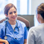 A young trainee doctor speaks with a patient.