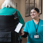 Aged Care GP employee Manpreet Kaur speaks with an Arcare Aged Care resident. Image: Leigh Henningham.