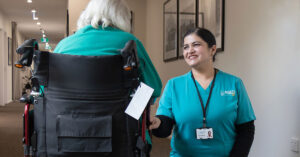 Aged Care GP employee Manpreet Kaur speaks with an Arcare Aged Care resident. Image: Leigh Henningham.
